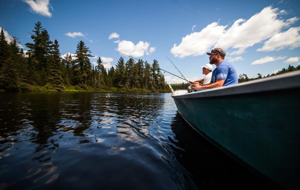 sun-and-father-fishing-in-a-calm-lake-in-wild-natu-PPLPHJY-resize.jpg